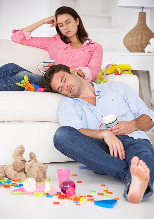 Exhausted parents on the sofa