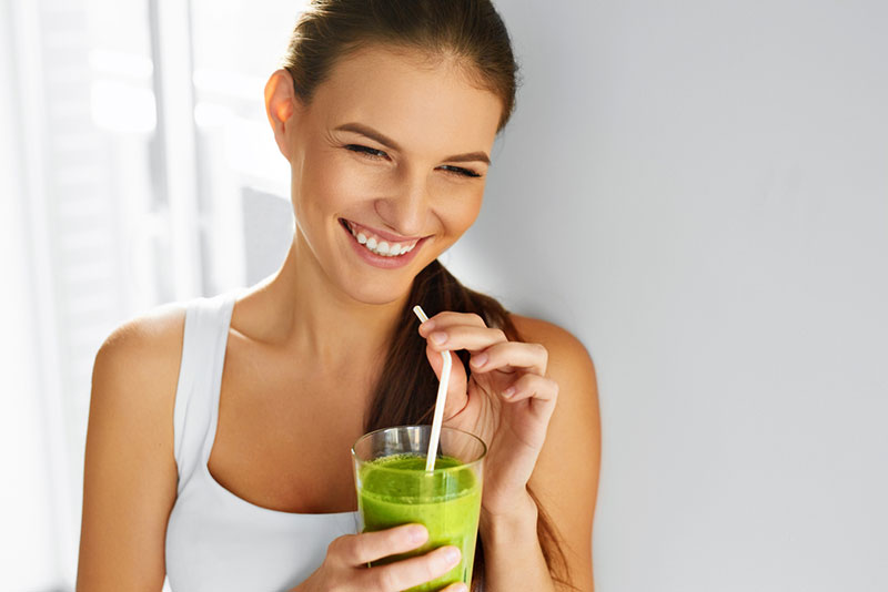 Attractive Woman drinking greens drink